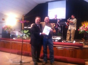 Glen being presented with Baptism Certificate